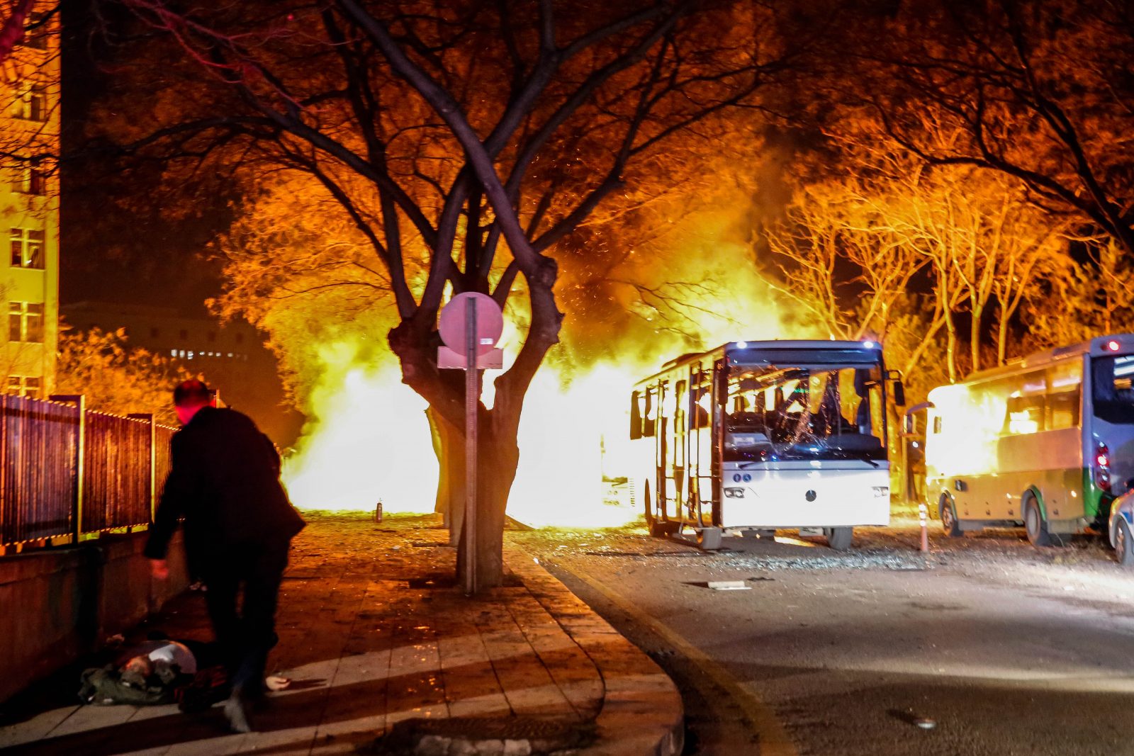 busses burning on street after explosion