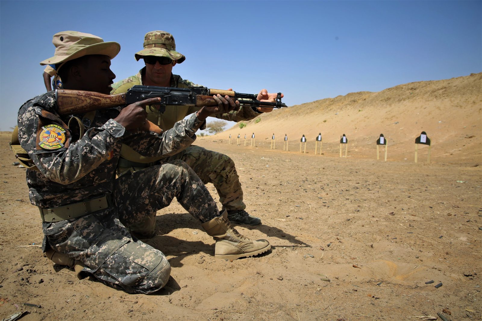 two soldiers doing marksmanship training with gun