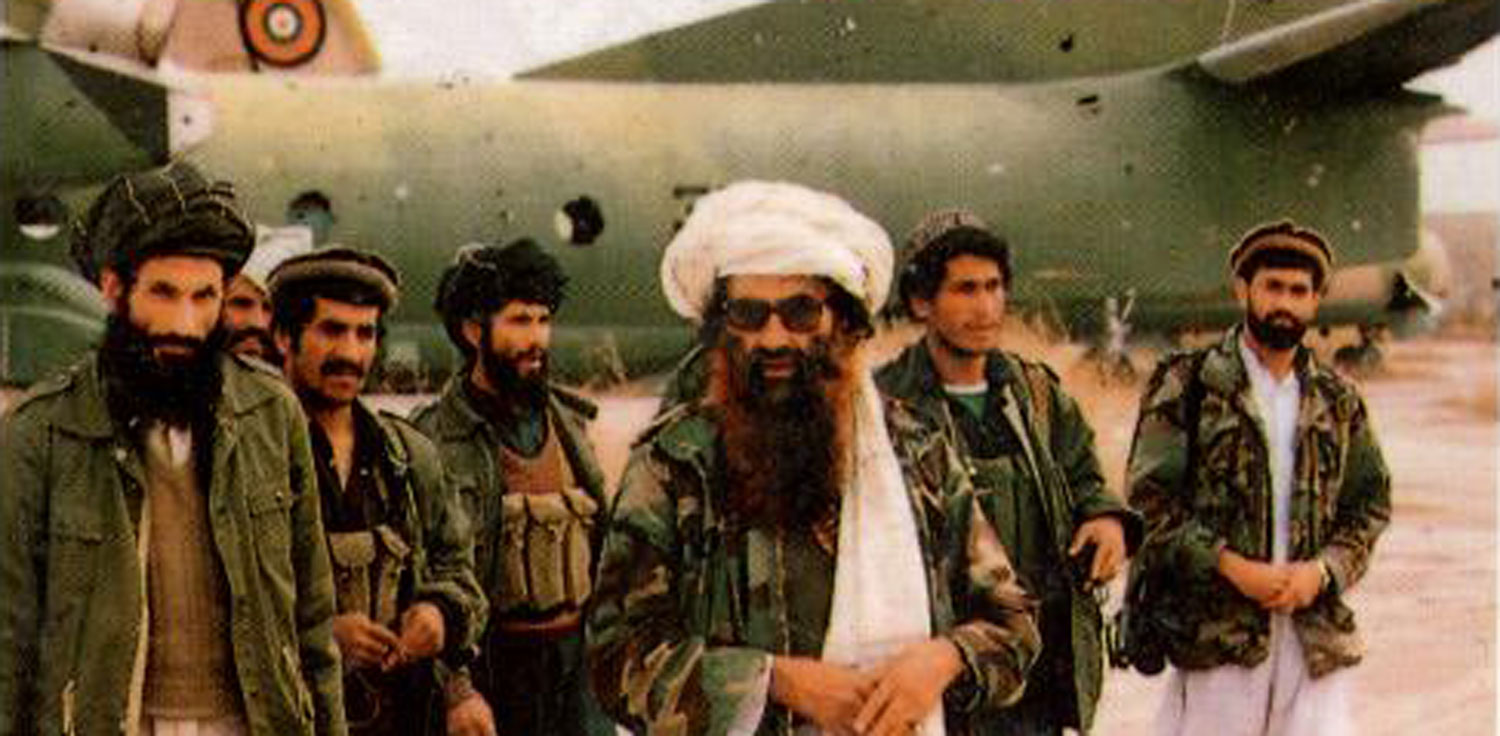 Haqqani Network – men in camouflage jackets in front of airplane